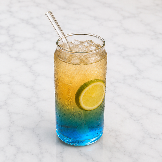  blue  drinkl served in a tall glass with ice, lemon slice, and a glass straw.