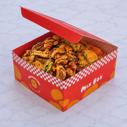 Open red and white FACTORYMIXBOX filled with potatoes and protein on a light gray background